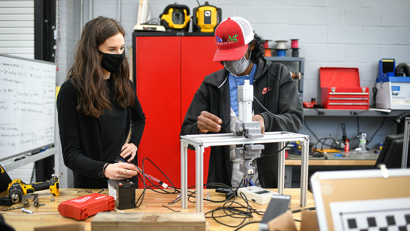 Sierra Young, left, and doctoral student Hemanth Narayan Dakshinamurthy are part of a team of NCSU researchers working to integrate unmanned surface and aerial vehicles to improve farming of oysters and other shellfish. (Photo by Marc Hall)